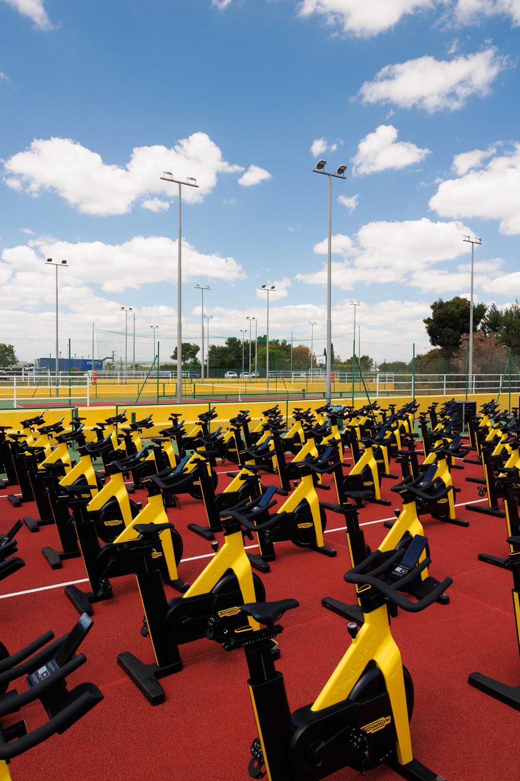 Emotion Fitness — Rows of spin bikes waiting on the court before the session
