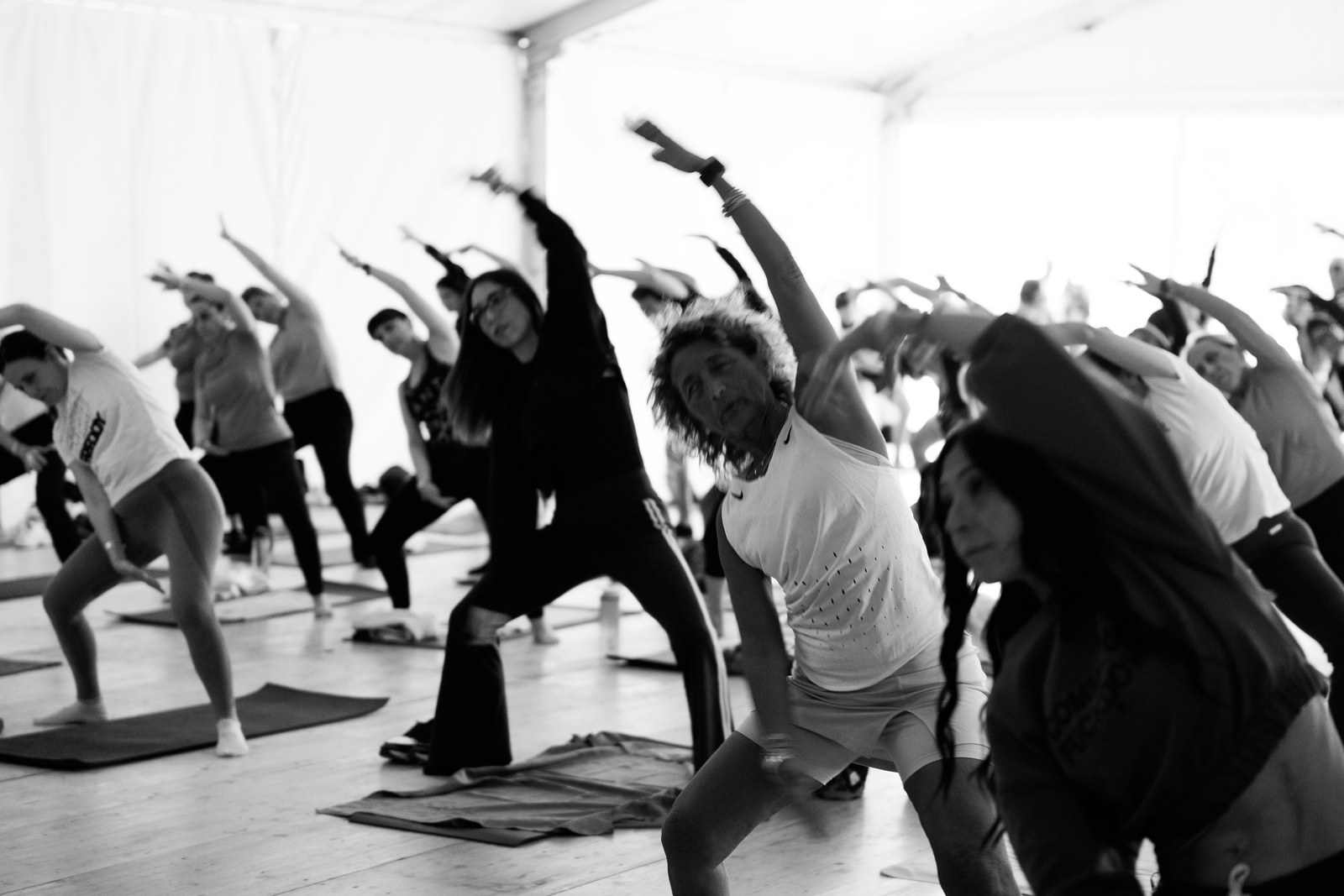 Emotion Fitness — Indoor class stretching out, shot in black and white